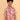 Child wearing a colorful patterned shirt and jeans on a beige background
