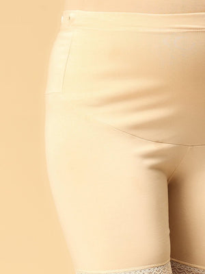 Side view of beige coloured high waisted mama boyshorts from the mom store showing adjustable bands