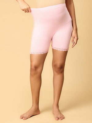 Model wearing pink coloured high waisted mama boyshorts from the mom store showing it's stretchability