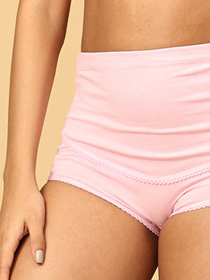 close up of model wearing pink over belly support maternity panties from the mom store