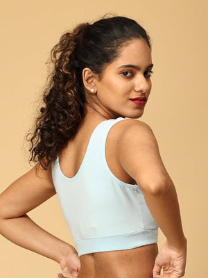 Backside view of Model wearing blue maternity nursing sleep bra from the Mom Store