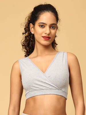 Model wearing grey maternity nursing sleep bra from the Mom Store