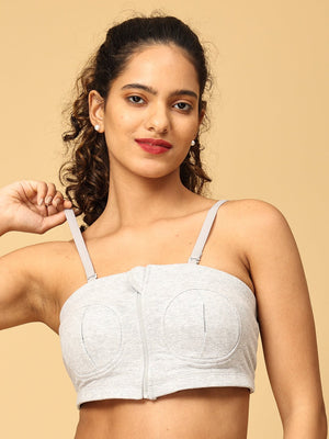  model wearing a grey coloured nursing pumping bra from the mom store, showing the stretchability of the bra
