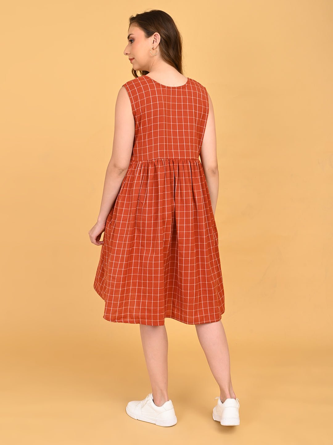 Back view of Copper Daybreak sleeveless maternity dress featuring copper grid print and gathered waistline.