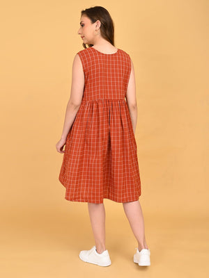 Back view of Copper Daybreak sleeveless maternity dress featuring copper grid print and gathered waistline.
