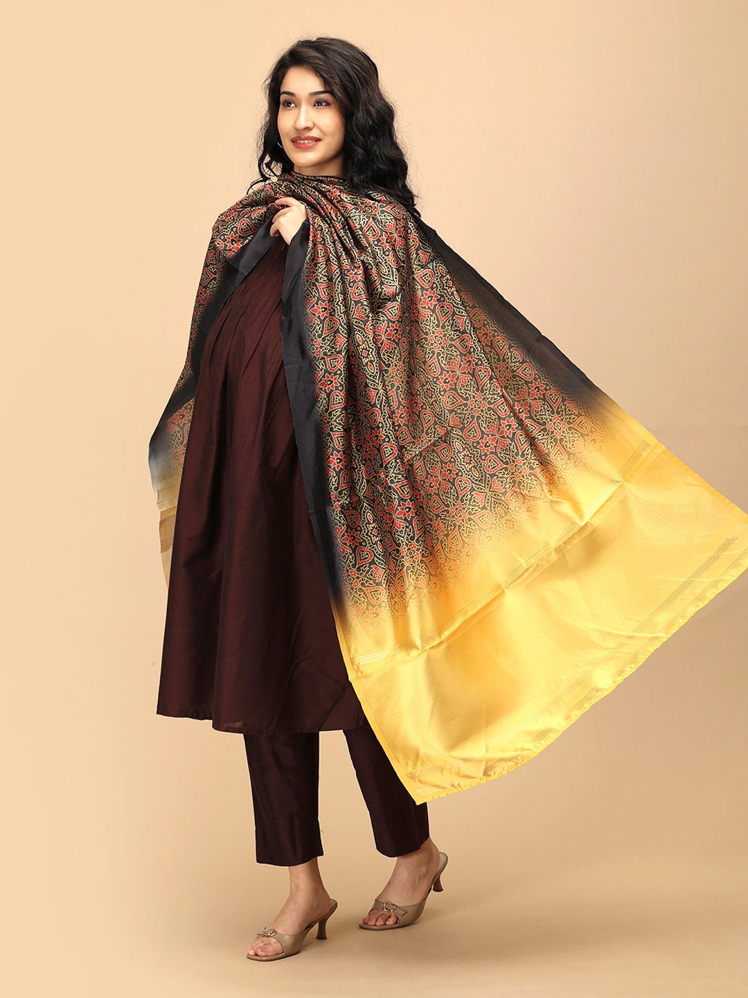 Pregnant woman in The Mom Store brown silk maternity kurta set paired with yellow-black printed dupatta.
