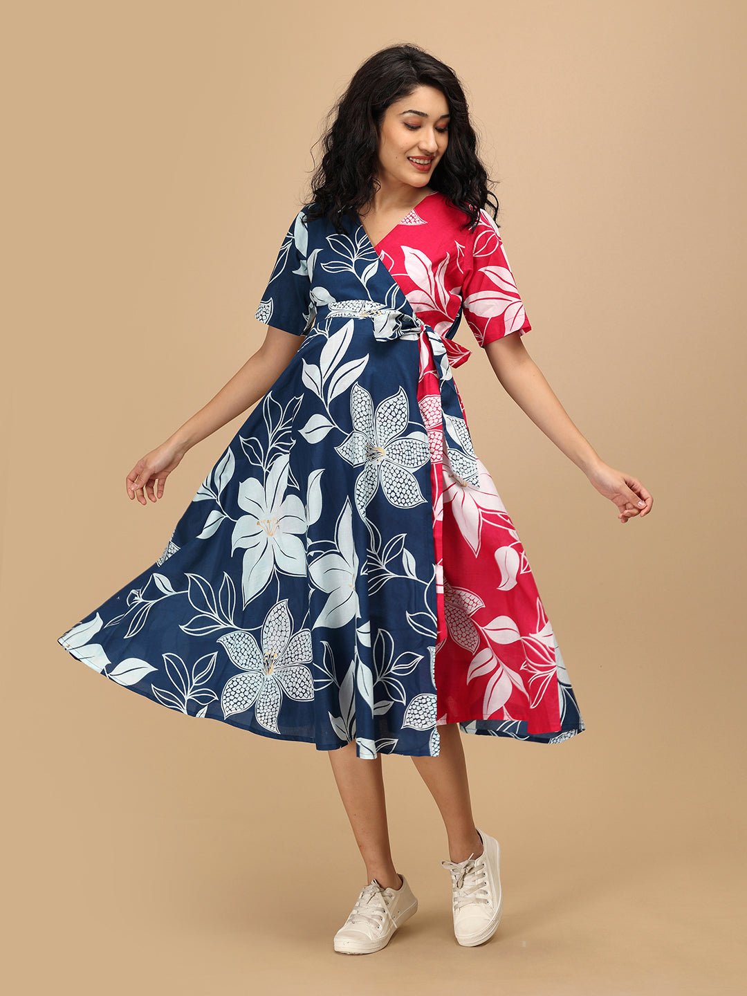 Twirling pose in The Mom Store Dual Bloom maternity and nursing wrap dress with large floral prints.