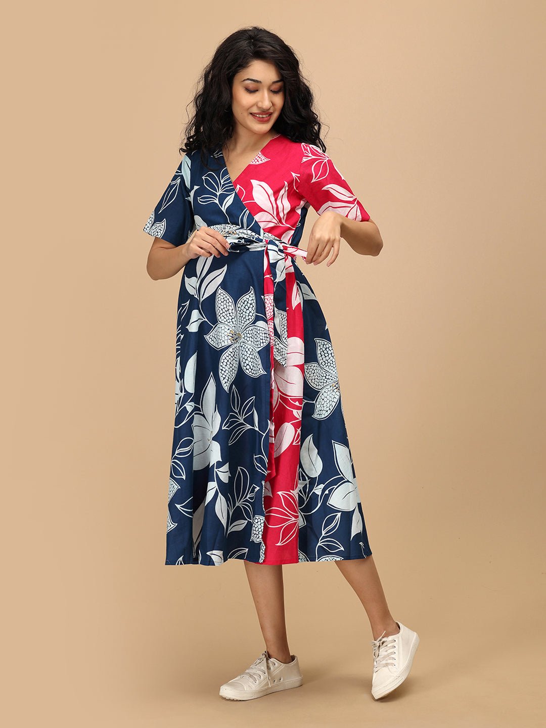 Side angle of The Mom Store Dual Bloom maternity and nursing wrap dress with pockets and tie belt.