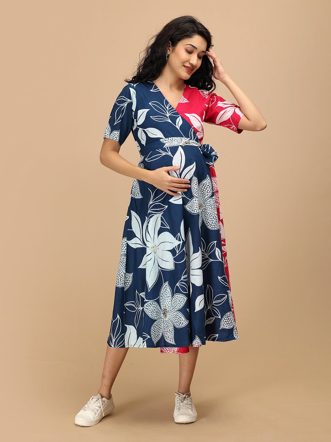 Front pose of pregnant woman in The Mom Store Dual Bloom wrap dress with floral navy pattern.