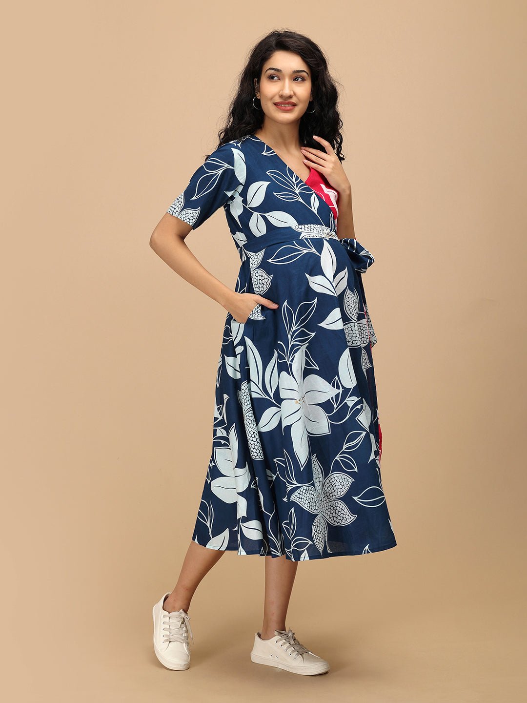 Side pose of The Mom Store Dual Bloom maternity wrap dress showing tie-up waist detail.