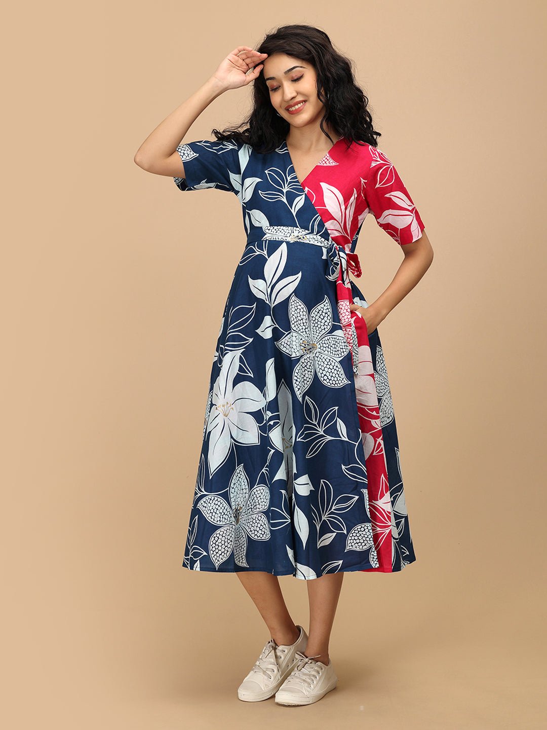 Smiling woman wearing The Mom Store Dual Bloom maternity and nursing wrap dress with bold florals.