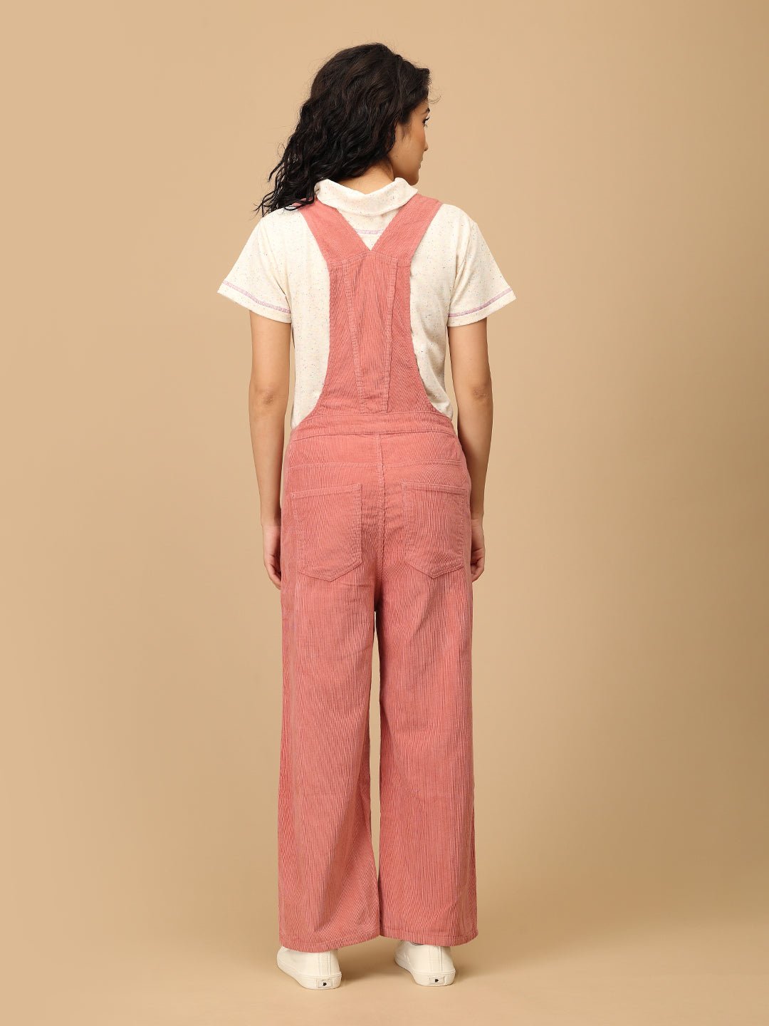 Back view of The Mom Store dusky rose corduroy maternity dungaree with cross-back straps.