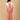 Back view of The Mom Store dusky rose corduroy maternity dungaree with cross-back straps.