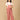 Pregnant woman smiling in The Mom Store dusky rose corduroy maternity dungaree front pose.