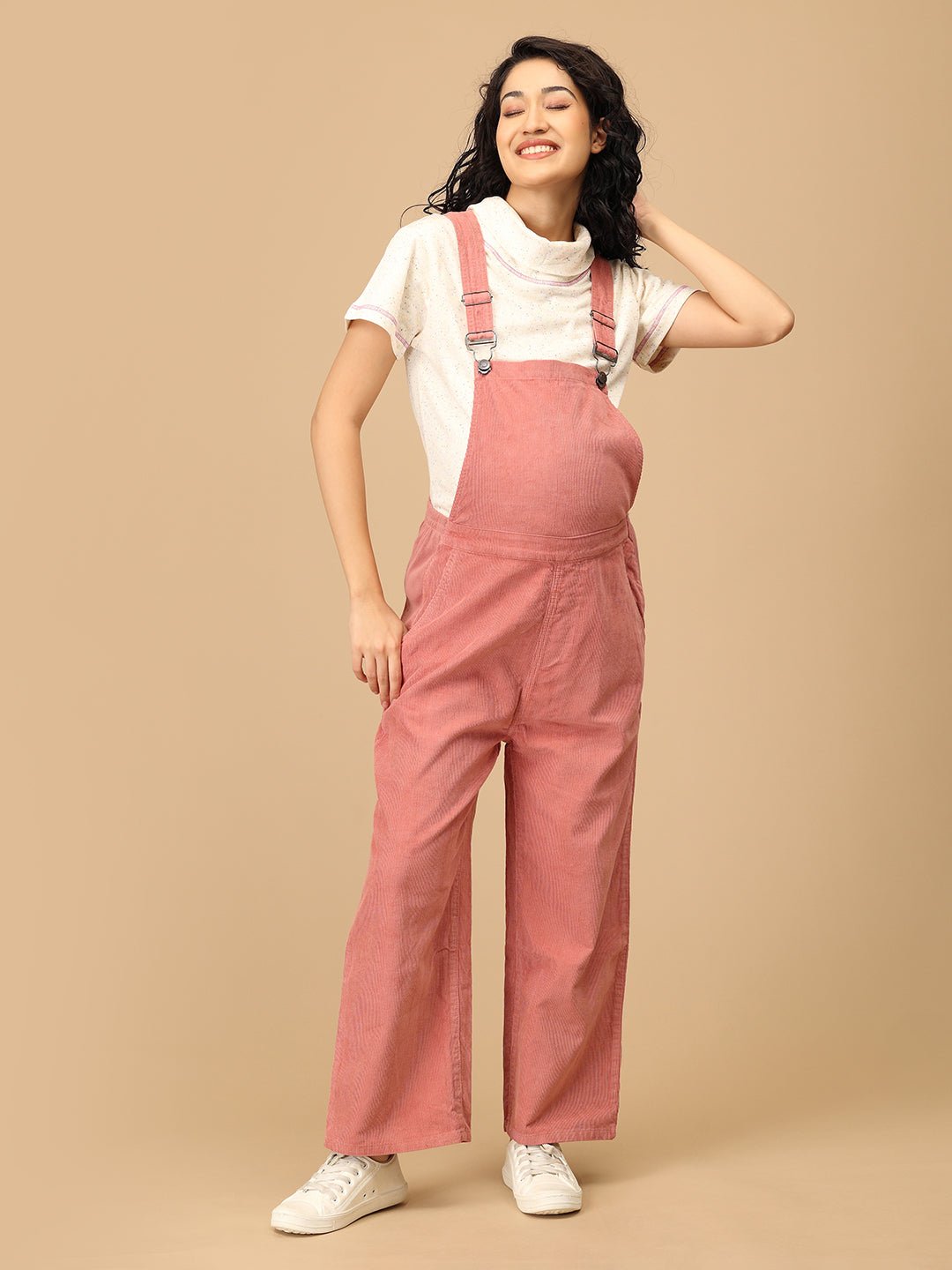 The Mom Store maternity dungaree in dusky rose corduroy with relaxed front pose.