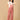 The Mom Store maternity dungaree in dusky rose corduroy with relaxed front pose.