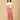Side pose of pregnant woman in The Mom Store dusky rose corduroy maternity dungaree.