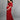 Playful side pose of a pregnant lady wearing wine coloured, off-shoulder maternity maxi dress from The Mom Store, touching her bump.