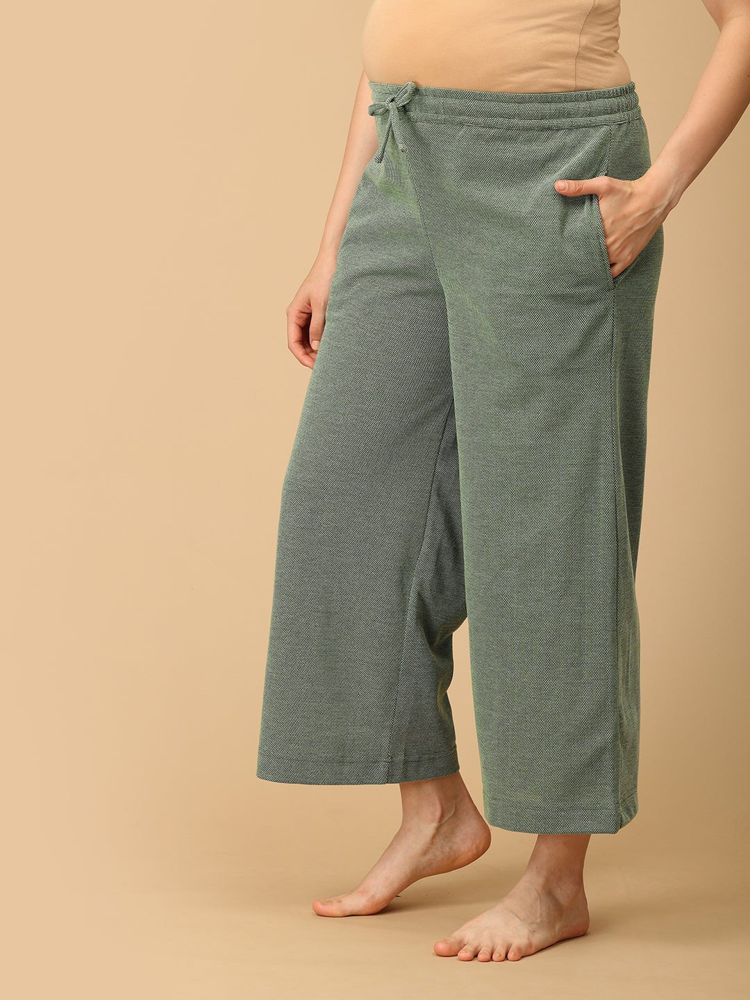 The Mom Store Evergreen Ease maternity wide-leg pants with drawstring waist and soft knit texture.