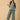 The Mom Store Evergreen Ease green maternity pajama set with relaxed wide-leg pants, model reading a book.