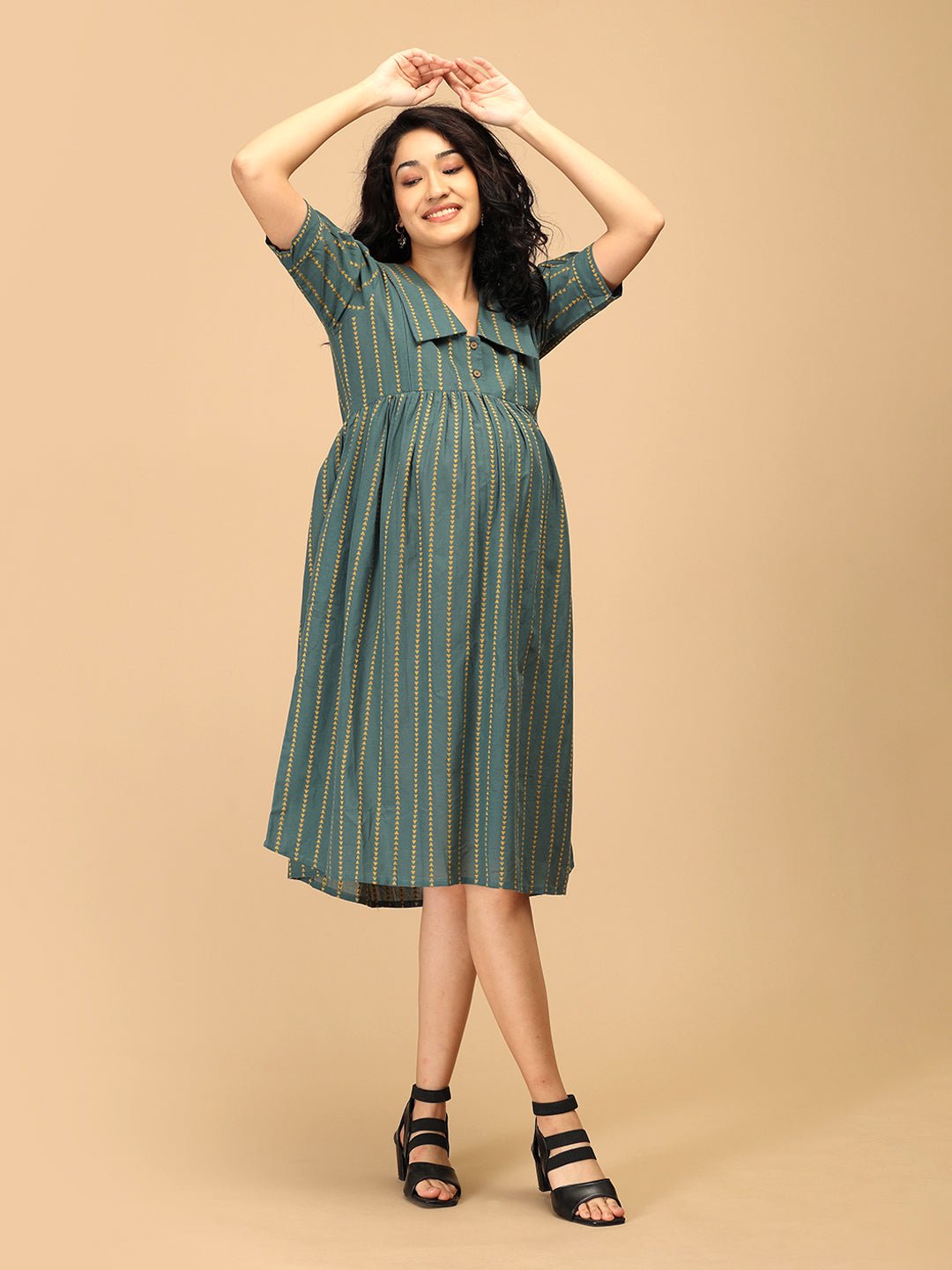 Twirling pose in The Mom Store green striped Everyday Ease maternity and nursing dress.