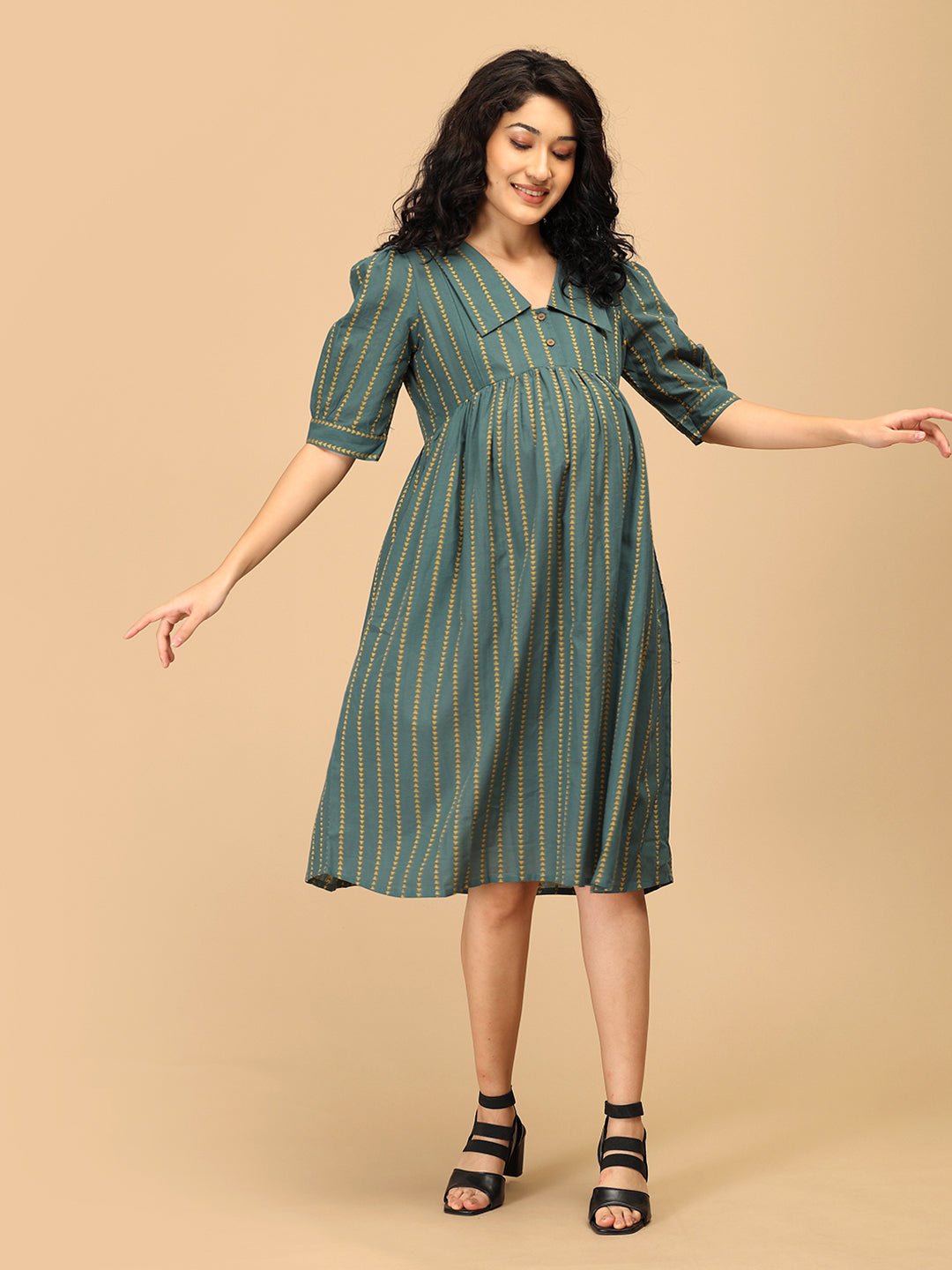 Front pose of The Mom Store green striped maternity dress with pockets and comfortable flare.