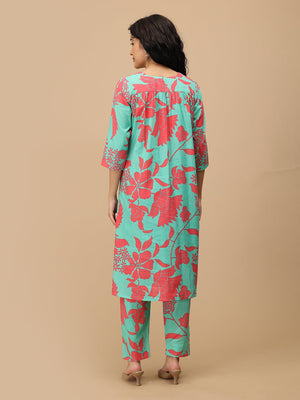 Back view of mint green floral maternity kurta with gathered yoke and all-over coral floral print.