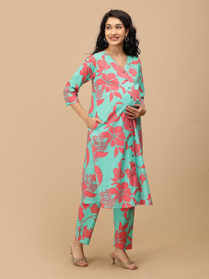 Model walking in a mint floral maternity and nursing kurta set, showcasing flowy fabric and easy movement.