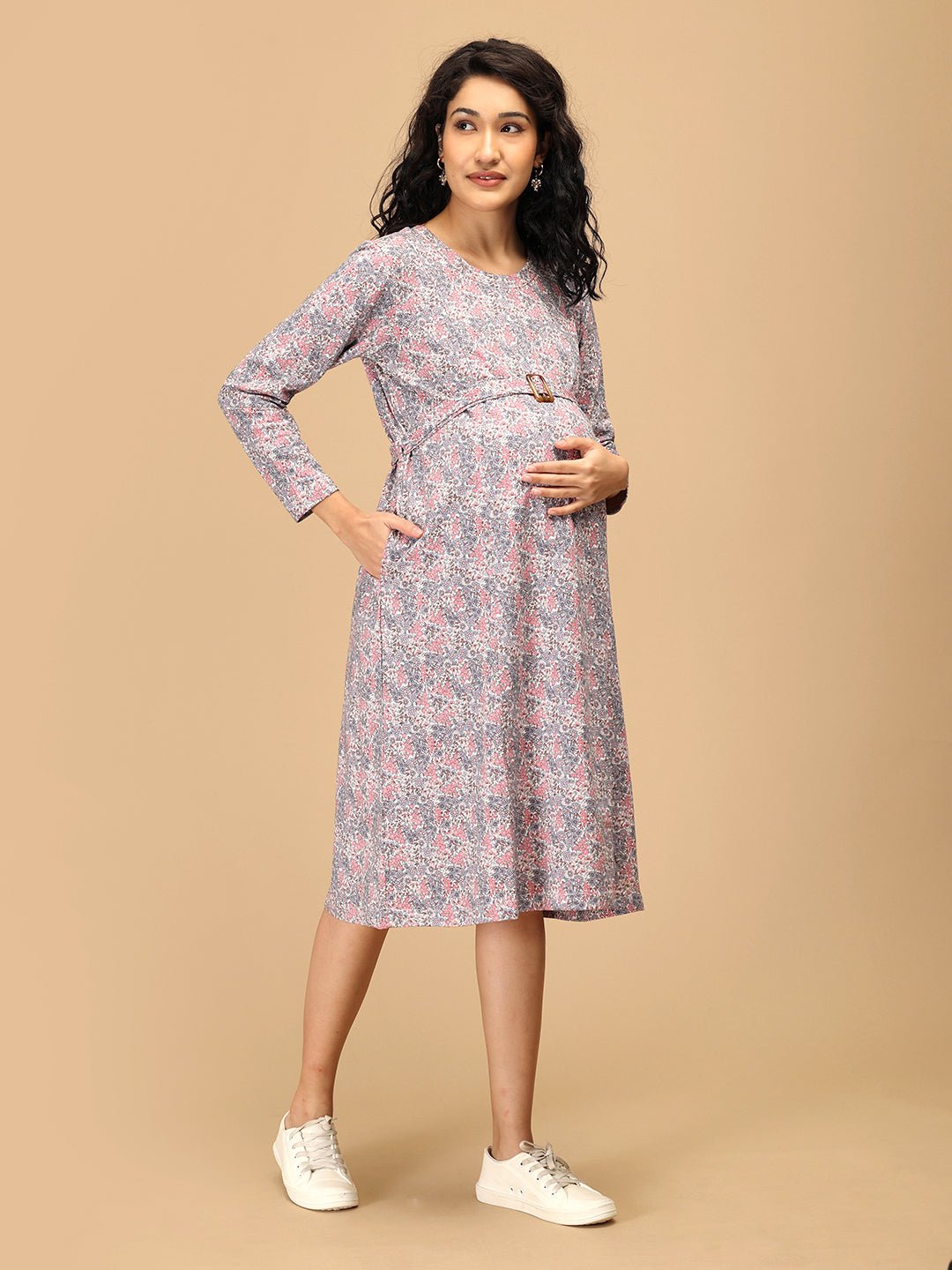 Model wearing Frosted Flowers Maternity Sweater Dress styled casually with sneakers