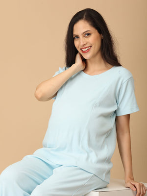 Smiling mom-to-be in The Mom Store Frosted Fluff maternity pajama set, soft cotton comfort nightwear.