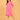 Angled side view of fuchsia maternity hoodie dress with hands on bump and pocket detail.