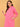 Upper body view of model wearing fuchsia maternity hoodie dress holding drawstring.