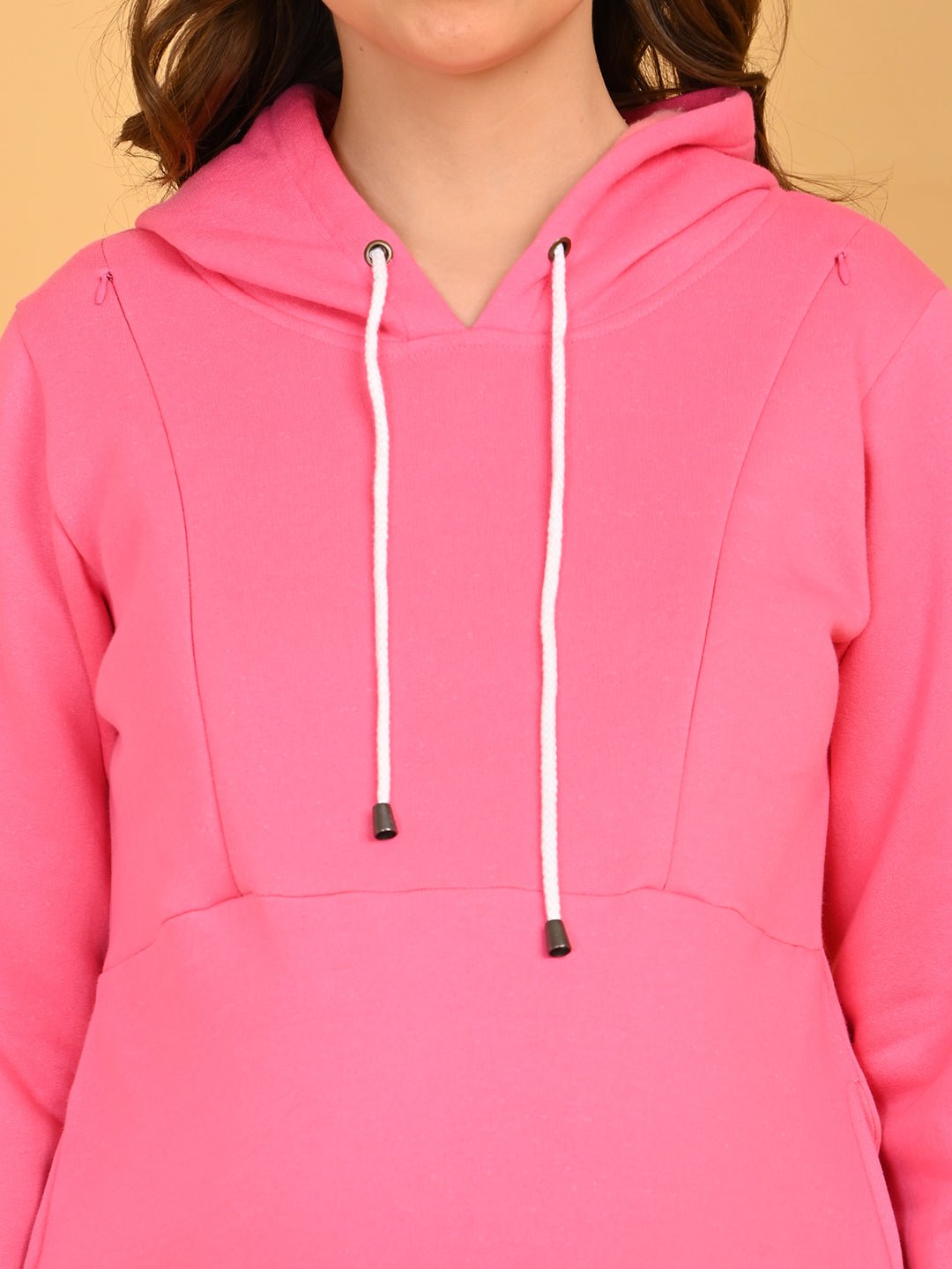 Close-up of fuchsia maternity hoodie dress with white drawstrings and long sleeves.