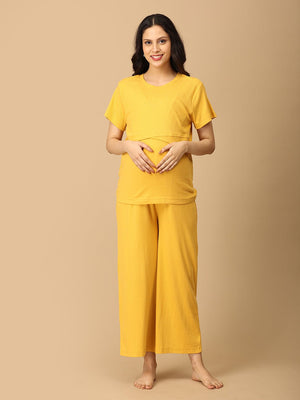 Pregnant Model wearing Golden Glow-Up Maternity and Nursing Nightwear Set from the mom store, touching her belly