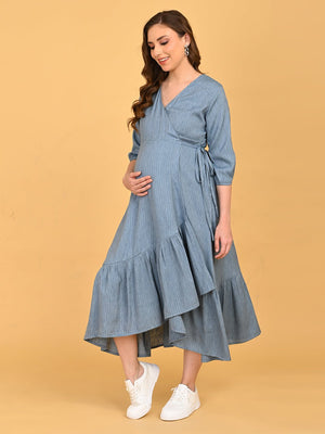 A smiling portrait of a pregnant lady wearing Grey Escape Maternity Wrap Dress with ruffled bottom