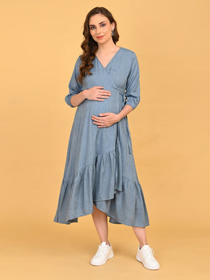 Image of a pregnant woman standing against an orange background wearing Grey Escape Maternity Wrap Dress
