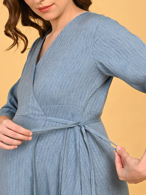 Image of a pregnant lady tying the knots of Grey Escape Maternity Wrap Dress