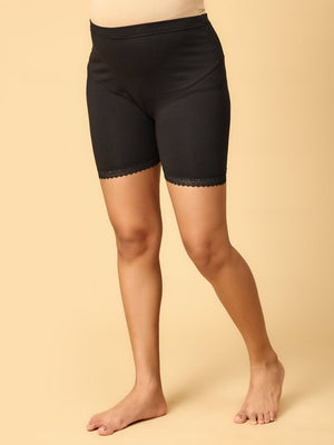 Model wearing black coloured over the belly support panties from the mom store