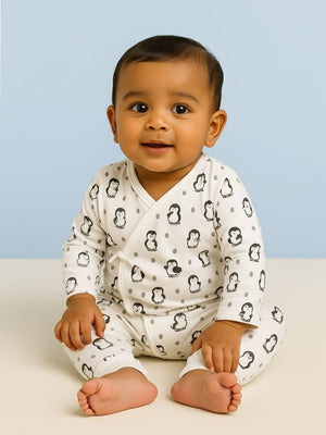 Picture of a baby wearing jabla style romper with penguin designs from the mom store