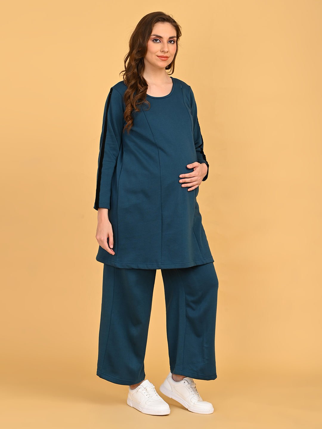 Pregnant model wearing Keepin’ It Teal maternity and nursing loungewear set, gently holding baby bump.
