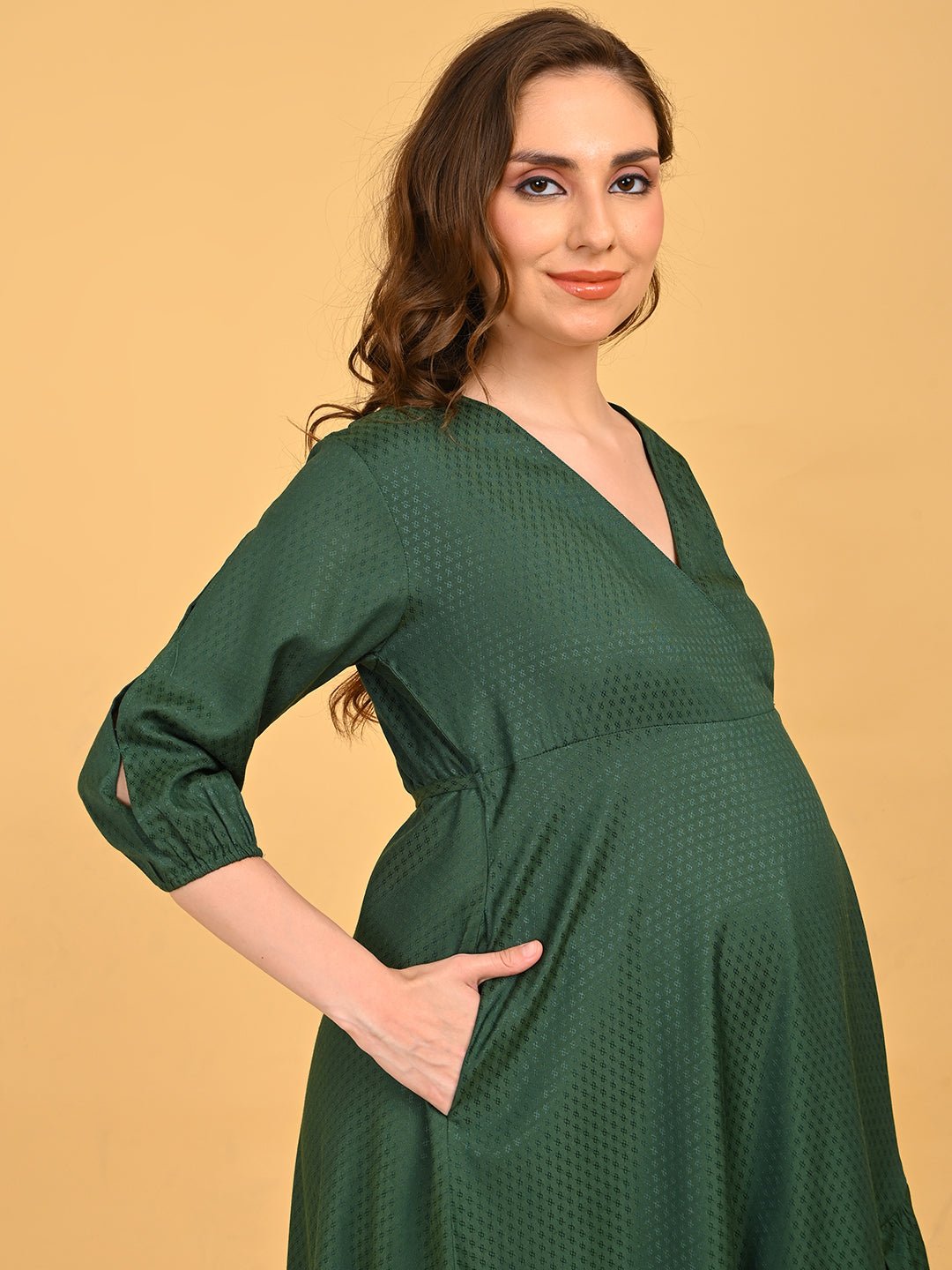 Leaf Me Breathless Maternity Wrap Dress three-quarter front pose with hand in pocket, showcasing soft textured fabric and comfortable drape.