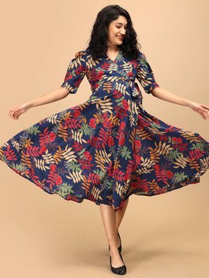Woman twirling in a navy blue floral maternity and nursing wrap dress showing the flared midi silhouette.