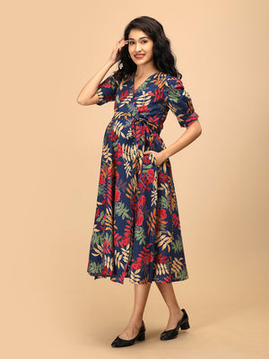 Angled front view of a navy blue floral maternity and nursing wrap dress with V-neckline and adjustable waist tie.