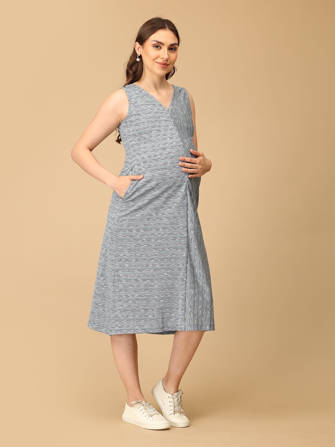 Stylish maternity and nursing dress with shrug, made from soft, breathable fabric. Features a hidden zipper for easy nursing access, sleeveless inner dress, and detachable long-sleeve shrug. Designed for comfort and versatility during and after pregnancy. Includes convenient pockets and offers a flattering fit for everyday wear.