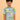 Child wearing a colorful shirt with hot air balloon pattern on a beige background
