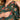 Close-up of concealed side zipper on green floral maternity dress for easy nursing access.