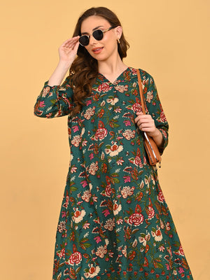 Model in green floral maternity and nursing midi dress styled with beige heels.