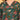 Close-up of green floral maternity dress featuring V-neckline and vibrant pink and cream floral print.