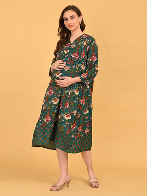 Model walking in green floral maternity and nursing midi dress styled with beige heels.