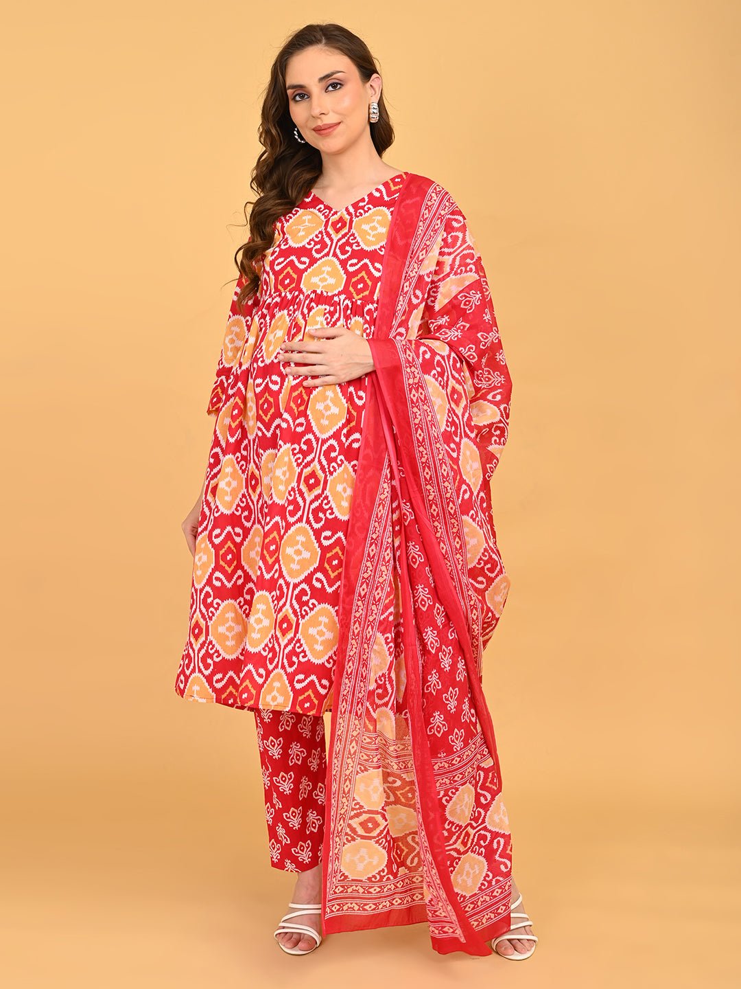Model wearing Magenta Atelier Maternity and Nursing Kurta Set With Dupatta featuring red and mustard ikat print with matching dupatta.